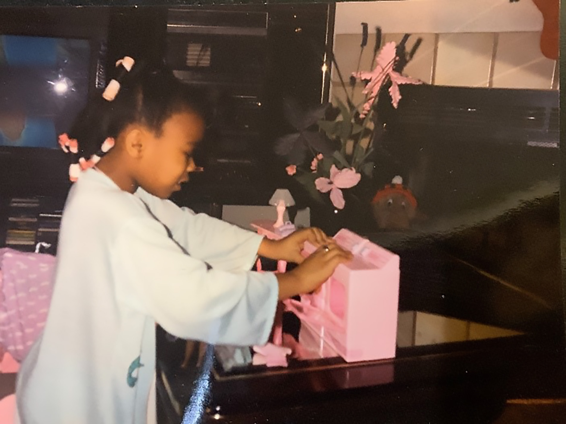 Photo of Keisha Clay playing with Barbies.