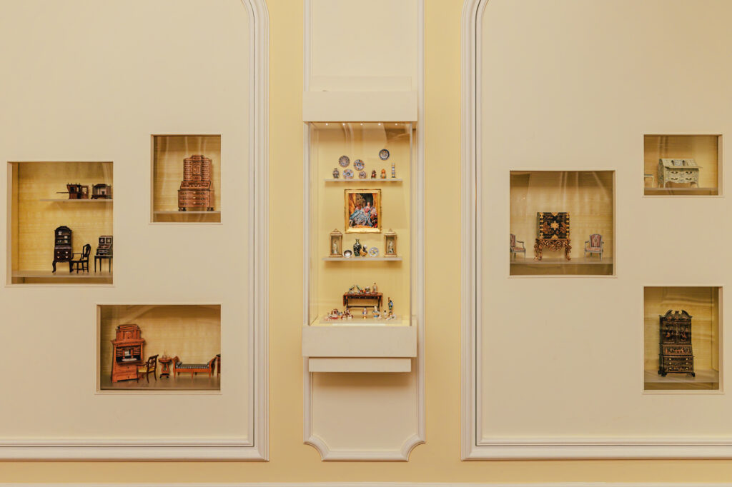 a wide shot of several small display cases in the miniature exhibition