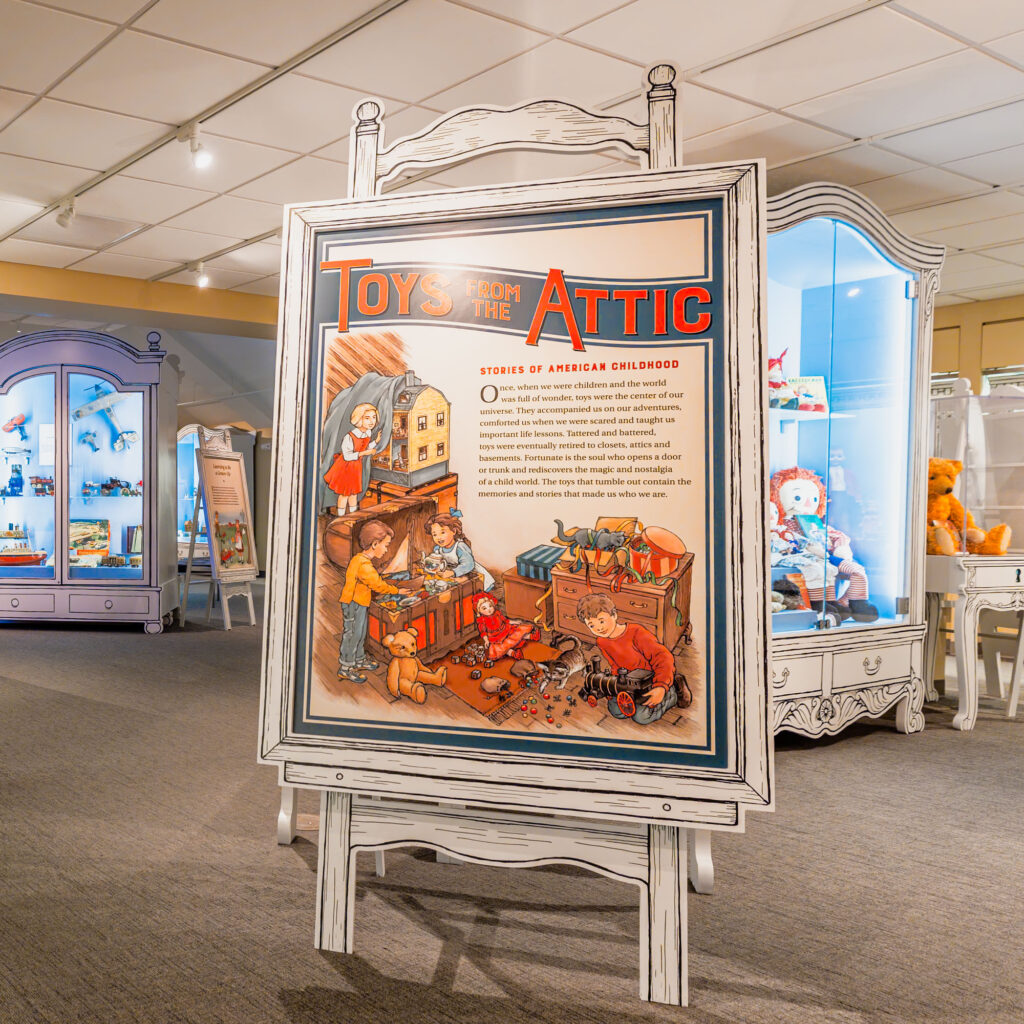 a wide shot of the sign reading "Toys From the Attic" in the exhibition hall