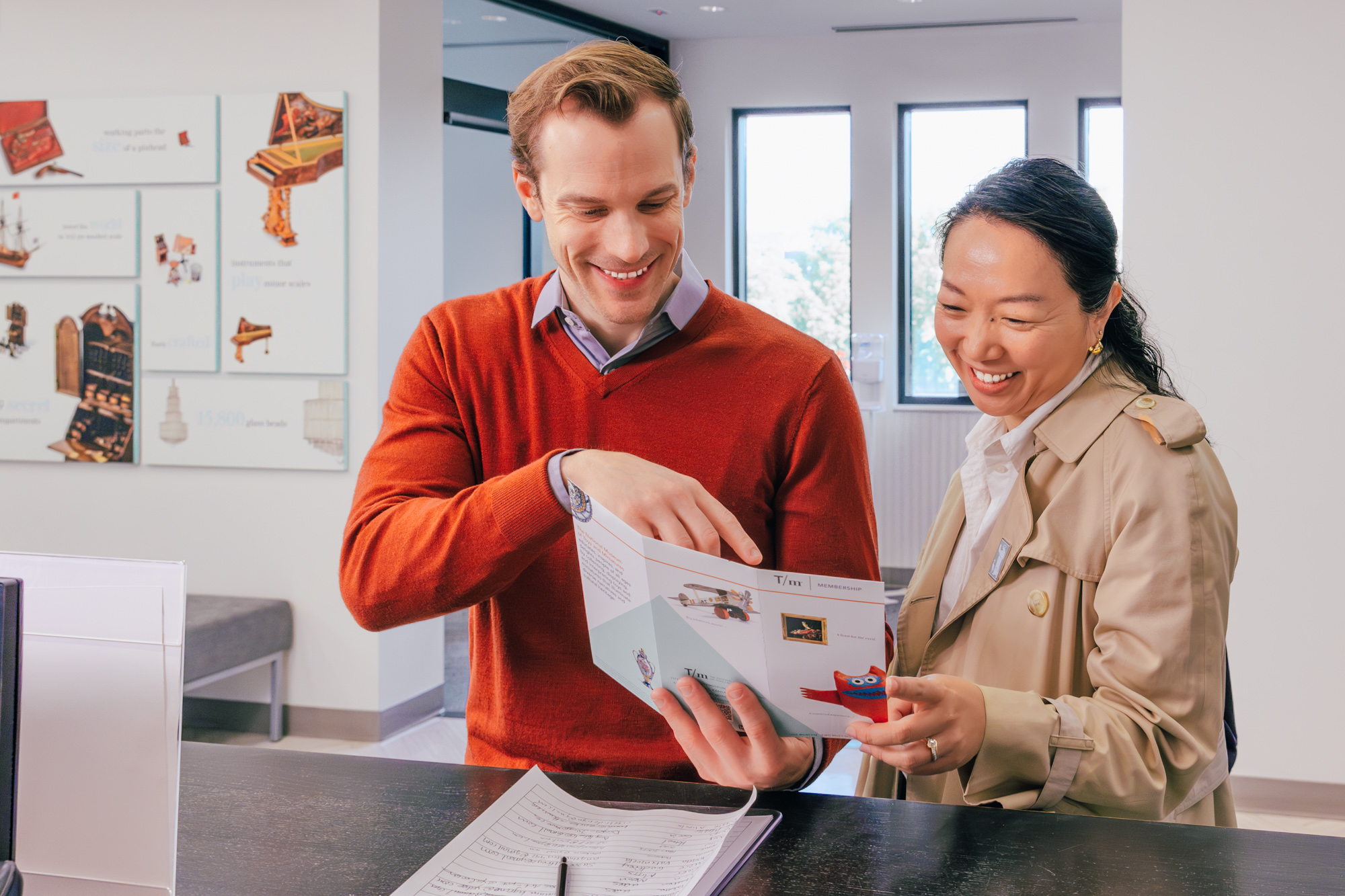 a couple look over a membership brochure at the Museum