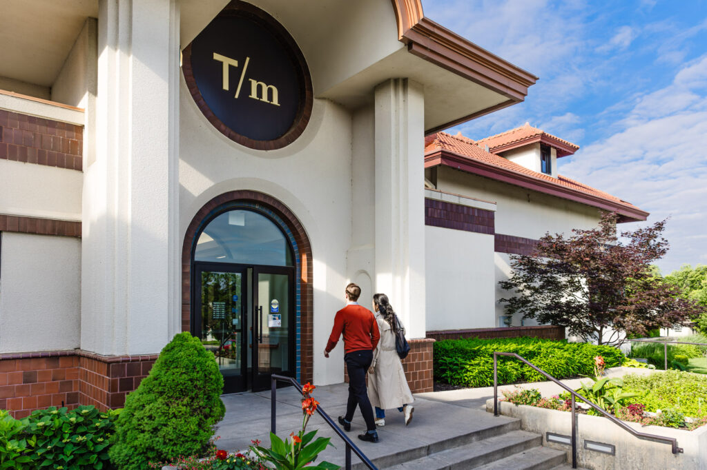 a couple walks toward the front door of the Museum