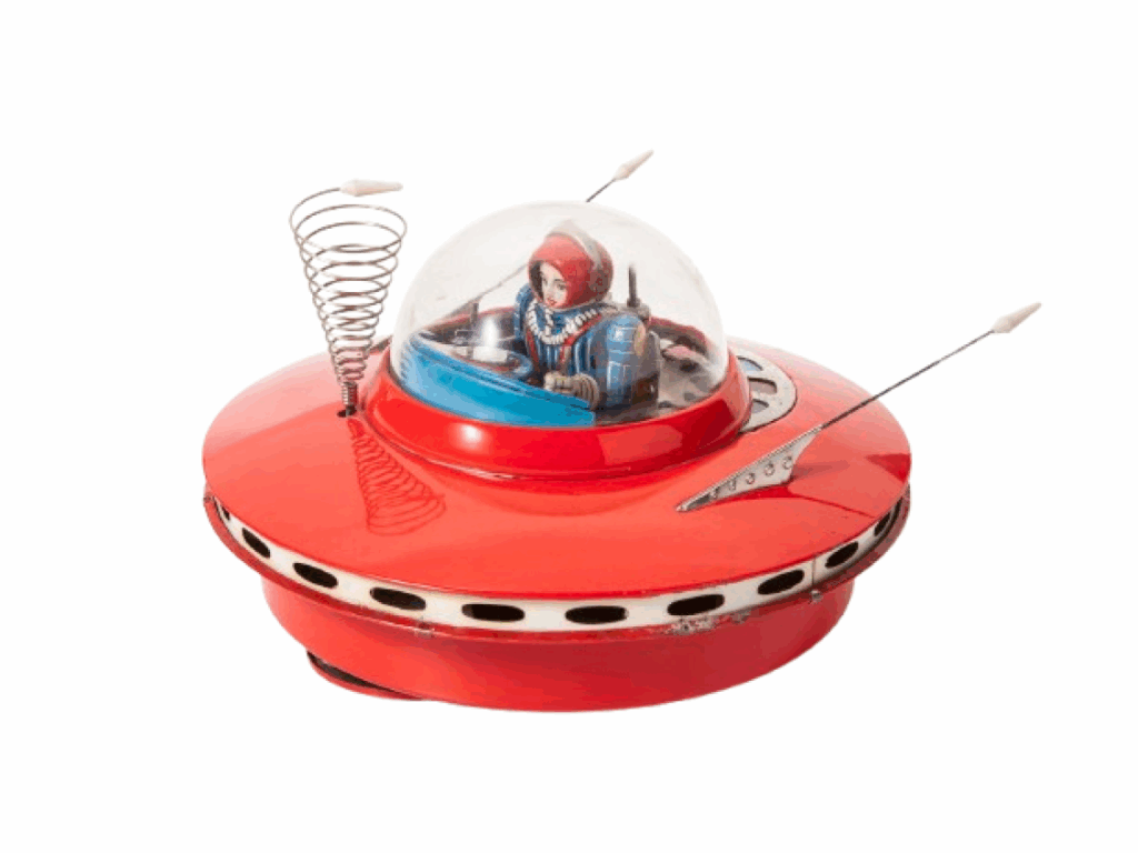 a vintage flying saucer toy with a visible pilot