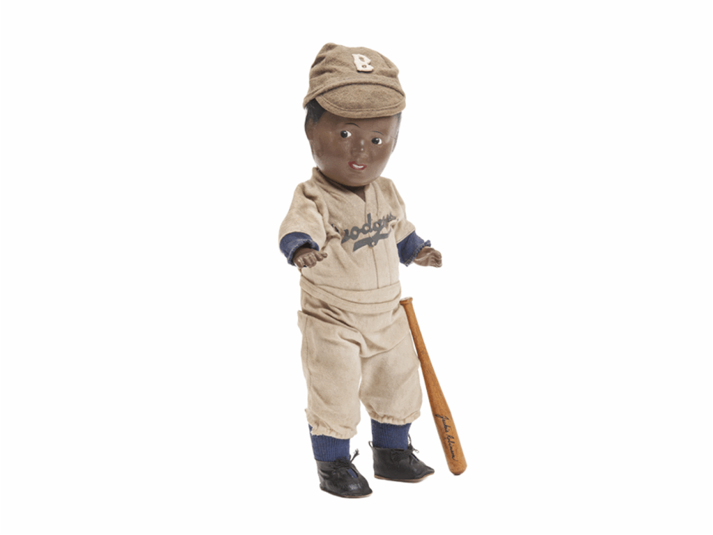 a vintage Jackie Robinson doll in a dodgers uniform