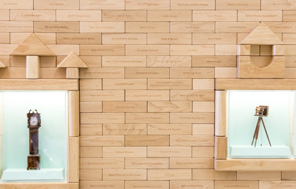 wood block wall, some of the blocks have names of legacy donors on them