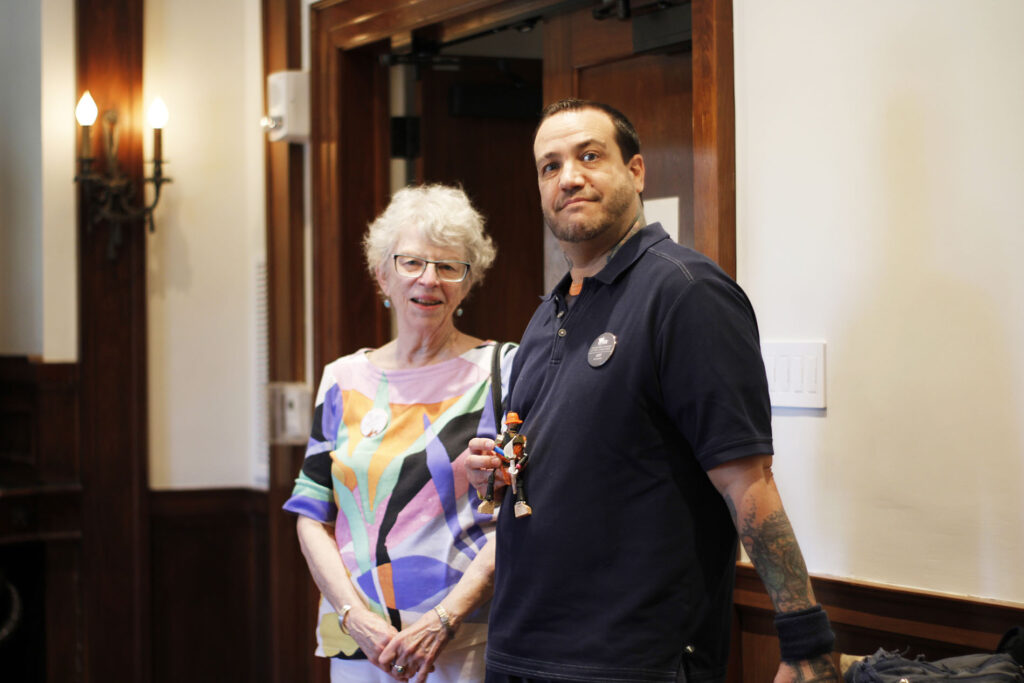 Two volunteers smiling for a photo in the Tureman Mansion.