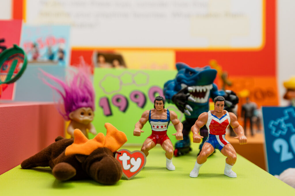 Image of toys from the 1990 including a troll and Beanie Baby.