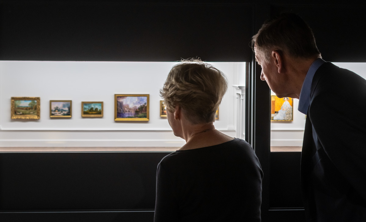 An older man and woman viewing the Museum's miniature art gallery.