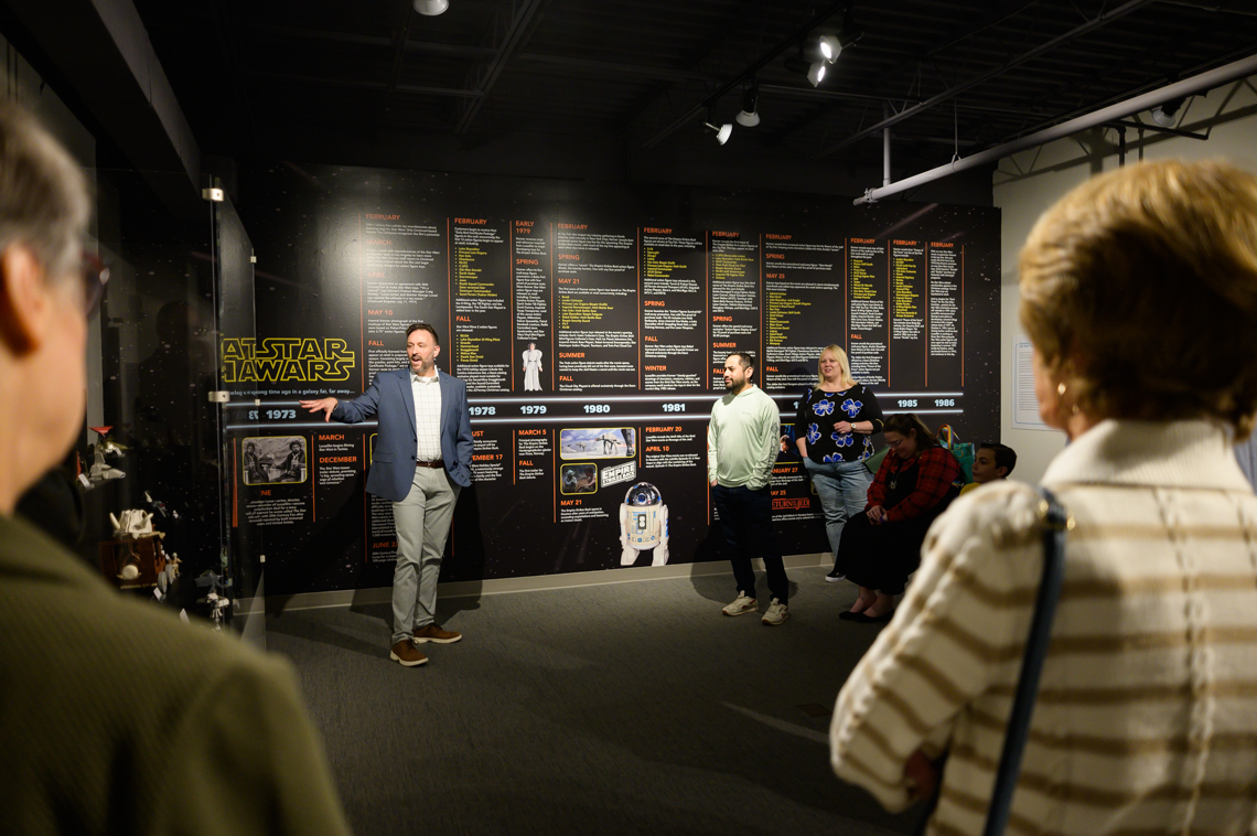 Visitors on a tour in the Museum's exhibition "The Nostalgia Awakens: Retro Kenner Star Wars Action Figure Toys."