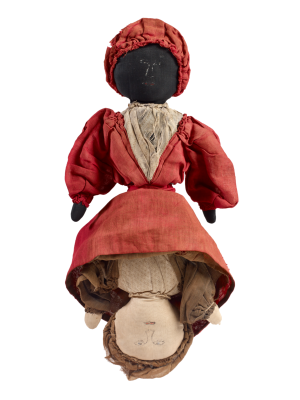 Historical Topsy Turvy doll in a red dress featuring both a Black woman and a white woman.