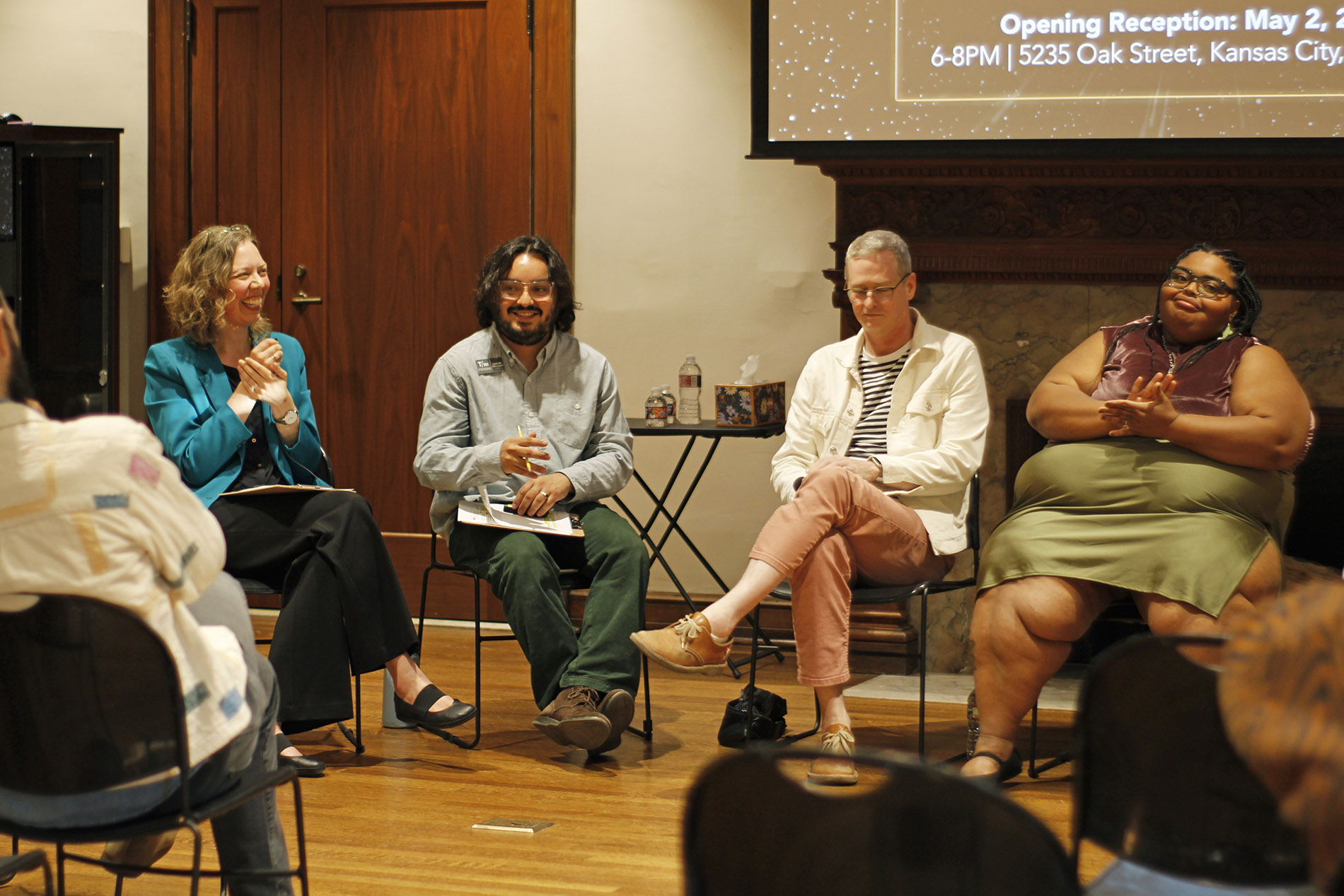 Museum staff moderating a lecture.