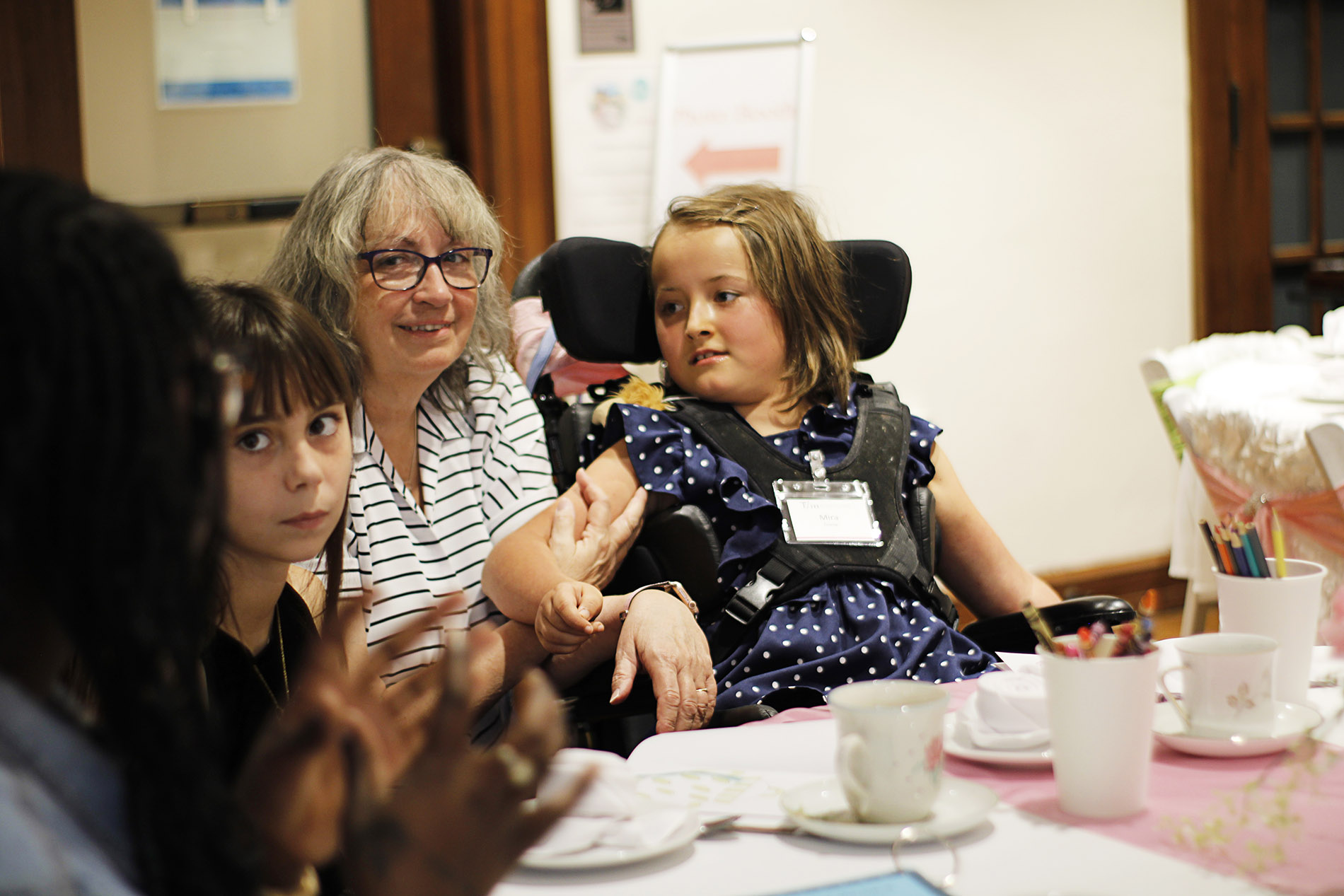 Child in wheelchair smiling.