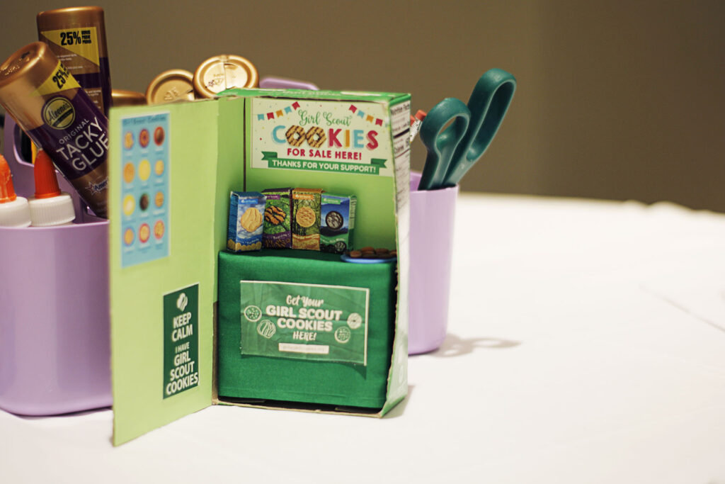 Miniature Girl Scout cookie booth sitting on a table.