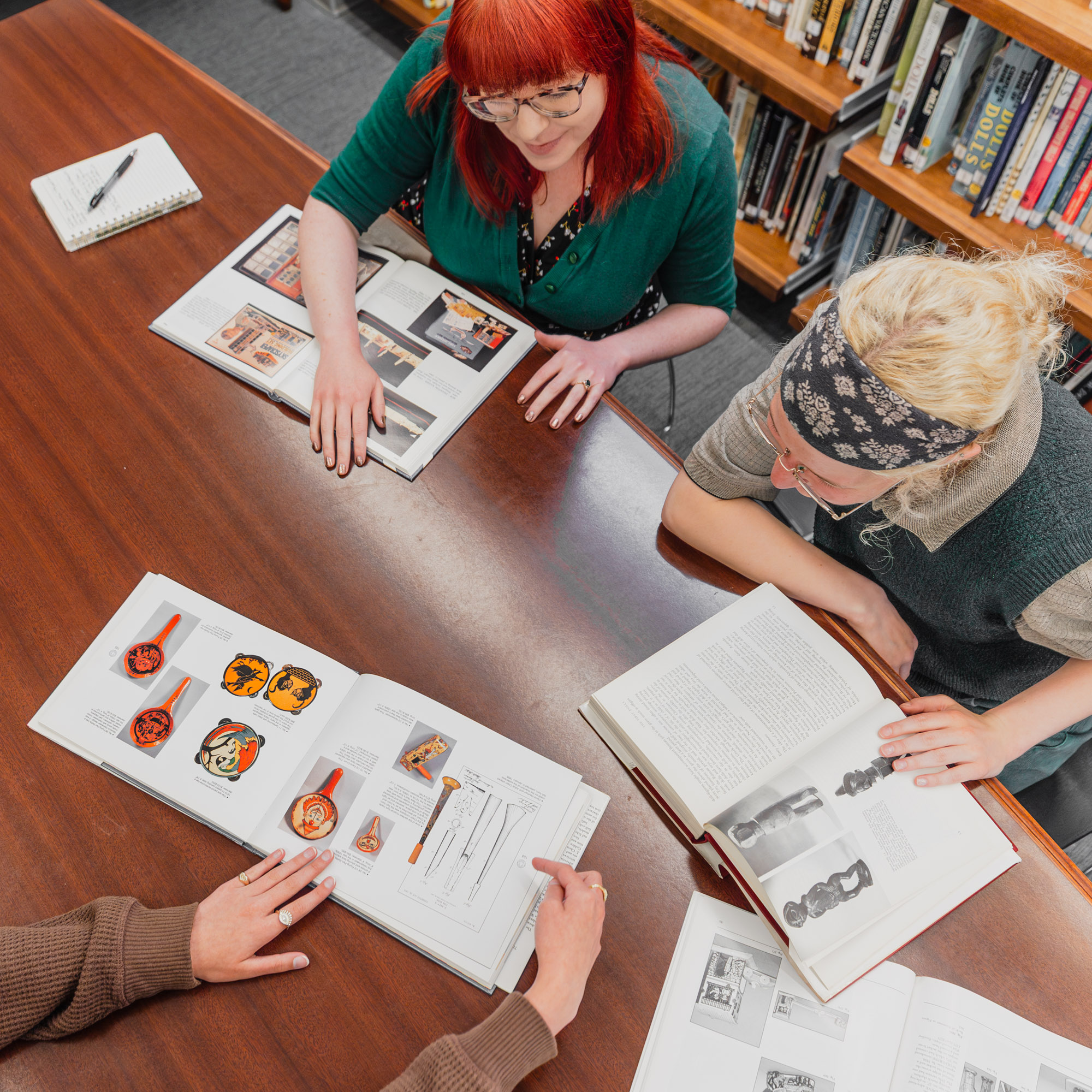 Visitors reading books in the Museum's library.