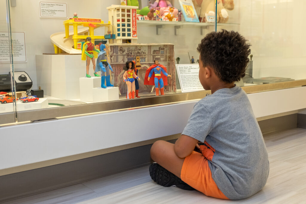 Young boy looking at toys in the "Iconic Toys" gallery.