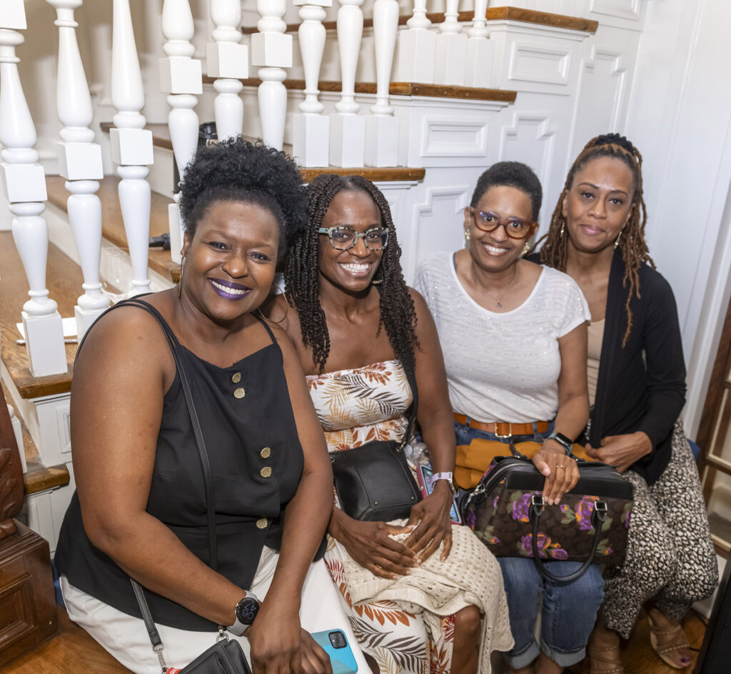 Four visitors at an opening reception in the Tureman Mansion.