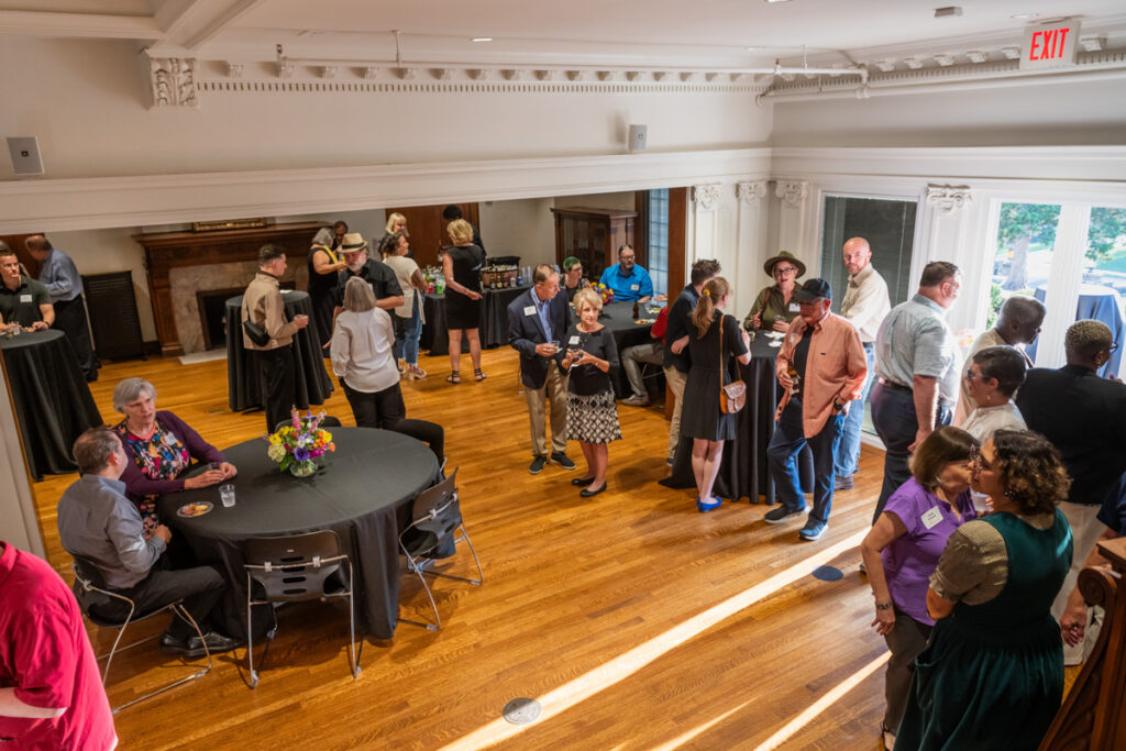 Event with large crowd in the Tureman Mansion event space.