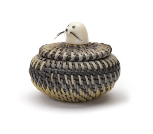 Miniature basket with a seal head on the lid.