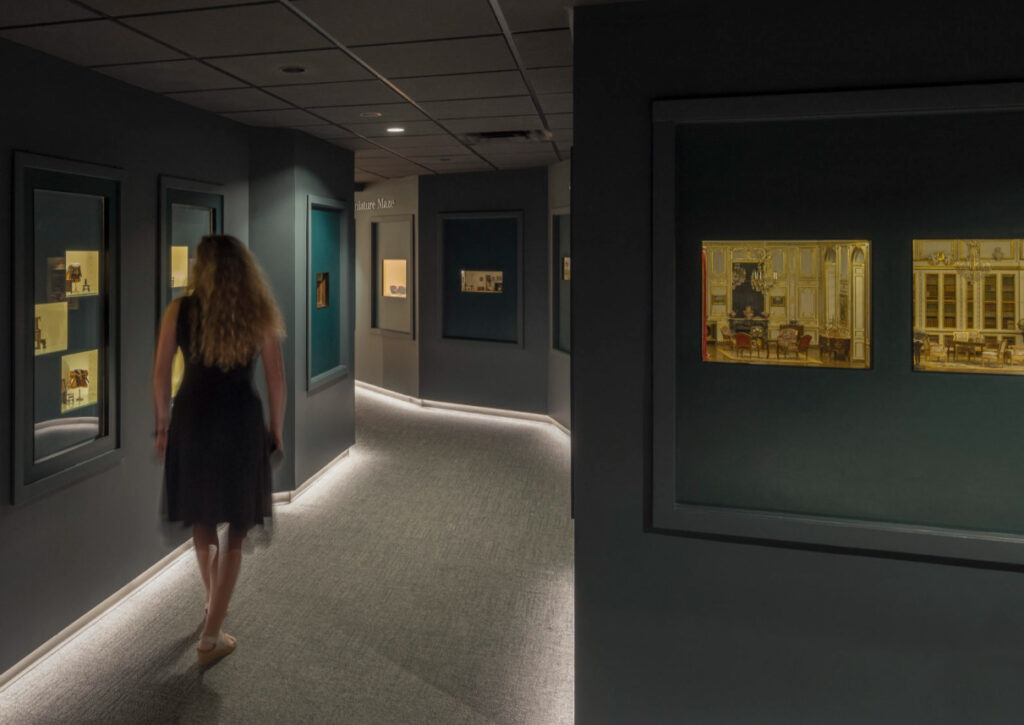 A woman looking at miniatures in the Miniature Maze.