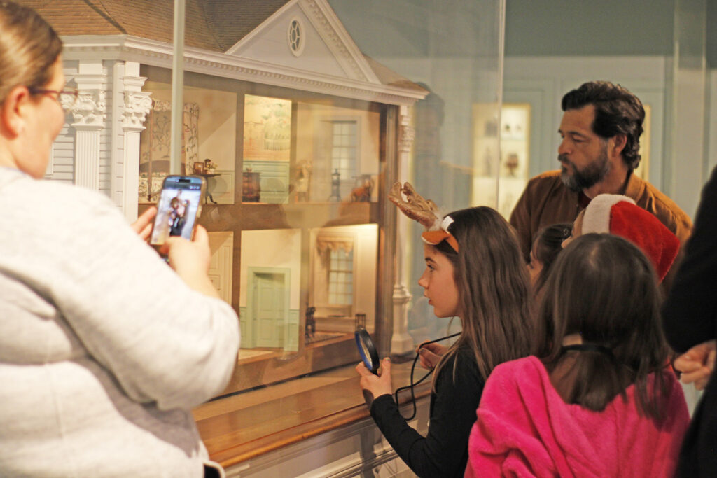 Kids looking at a miniature house.