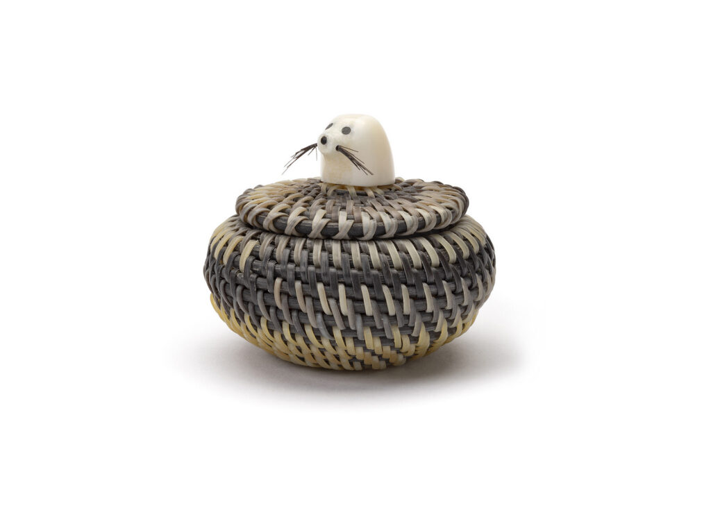 Miniature basket with a seal head on the lid.
