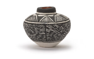 Miniature polychrome jar with black and white stripes.