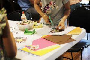 A child cutting up paper during a craft.